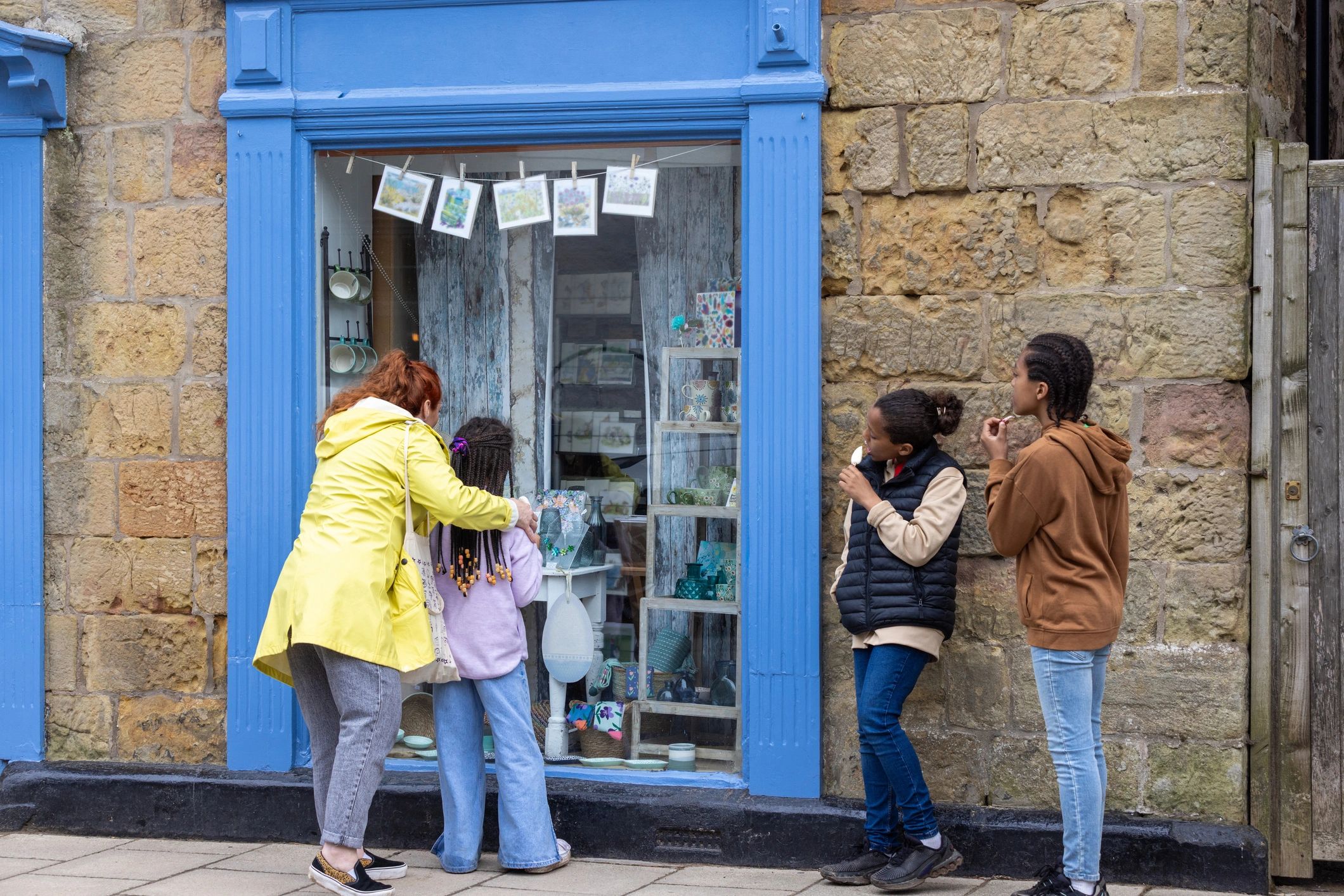 Customers viewing a local shop window display