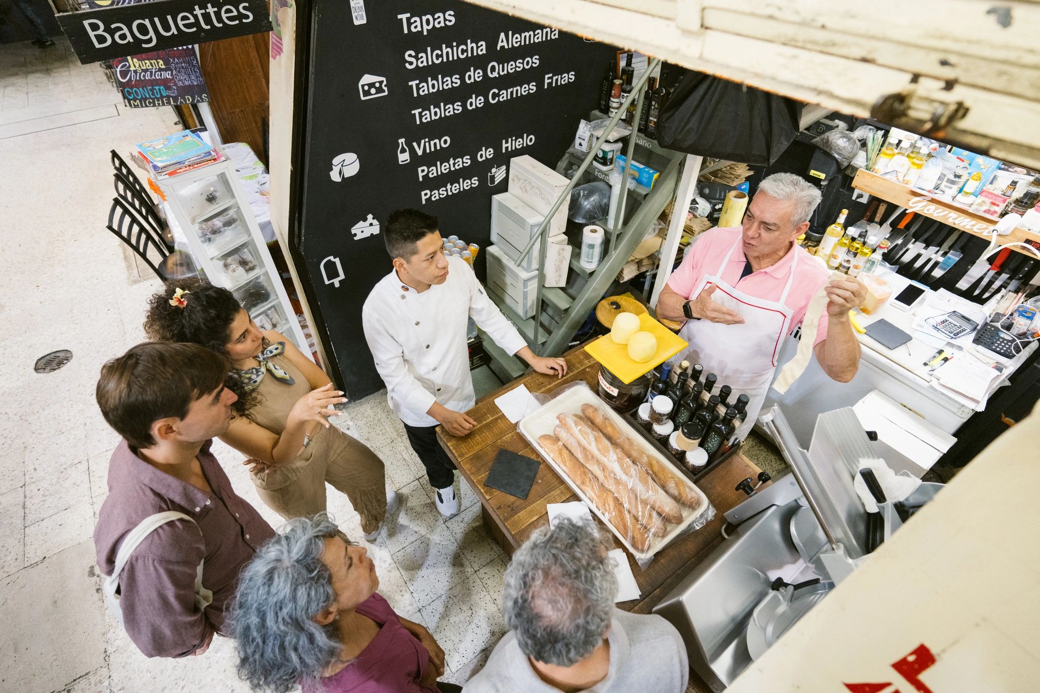 Business owner speaking with customers at a market stall